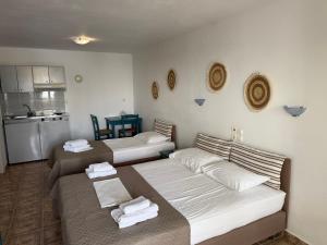 a living room with two beds and a kitchen at 9 Muses in Elafonisos +34 photos