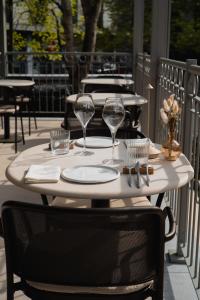 a table with wine glasses and napkins on a patio at Alfred Hotel & Gastro Bar in Marche-en-Famenne