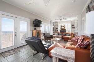a living room with a couch and a table at Fairwinds by Oak Island Accommodations in Caswell Beach +128 photos