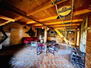 a room with a table and chairs and a couch at Beautiful Rustic Cabin in Prejmer