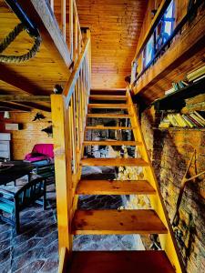 a wooden staircase in a room with wooden ceilings at Beautiful Rustic Cabin in Prejmer
