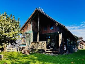 an old wooden house in a field of grass at Beautiful Rustic Cabin in Prejmer