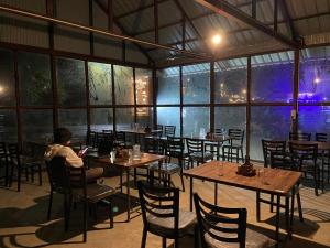 a person sitting at a table in a restaurant at GoingZero Luxury Camps Jispa in Jispa