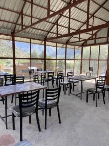 a group of tables and chairs in a tent at GoingZero Luxury Camps Jispa in Jispa