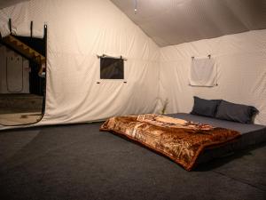 a tent with a bed in the middle of it at GoingZero Luxury Camps Jispa in Jispa