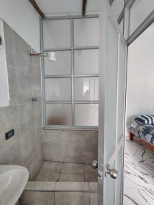 a bathroom with a shower and a sink at Casa Jardin in Ayacucho