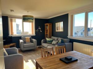 a living room with a couch and a table at Buaile nan Carn in Kilmuir