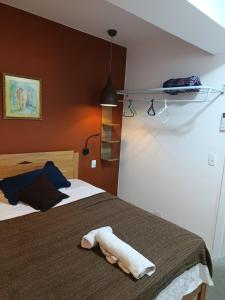a bedroom with two beds and a towel on the bed at Lapa Bed & Breakfast in Rio de Janeiro