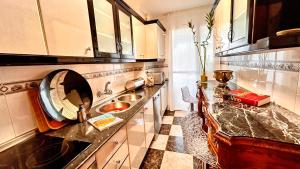 a kitchen with a sink and a counter top at Íberos Royal in La Zubia