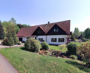 a large white house with a brown roof at Pension Renata in Šediviny