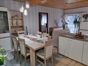 a kitchen and dining room with a table and chairs at Pension Renata in Šediviny