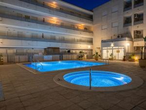 a large swimming pool in the middle of a building at Apartamento Luz de Almoradi in Almoradí