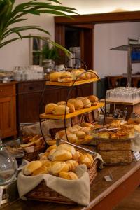 a table topped with baskets of bread and baskets of pastries at Grande Hotel Canela in Canela +169 photos