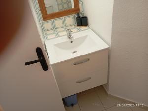 a bathroom with a white sink and a mirror at les pieds dans l'eau 2 - Piscine chauffée in Le Barcarès +19 photos