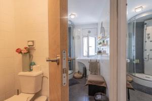 a bathroom with a toilet and a sink at Tutto Passa Lloret in Lloret de Mar