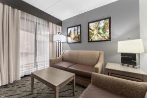 a living room with a couch and a table at Best Western Braddock Inn in La Vale