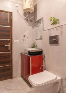 a bathroom with a toilet and a sink at Silver Crest Hotel Kasauli in Kasauli +35 photos