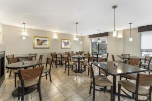 a dining room filled with tables and chairs at Best Western Braddock Inn in La Vale