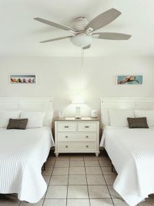 a bedroom with two beds and a ceiling fan at Blackfin Resort and Marina in Marathon +40 photos