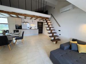 a living room with a staircase and a dining room at Apartment Anchor Luxury in Slatine