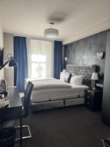 a bedroom with a large bed and a window at Pension Burkhardt in Meißen