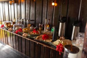 a buffet line with many different types of food at Beach House NATUREZA self check-in in Itacaré