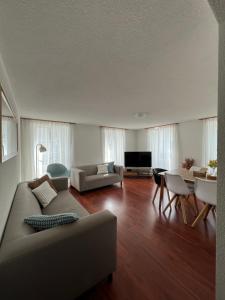 a living room with a couch and a table at Nimbuzzz Apartments in Unterseen