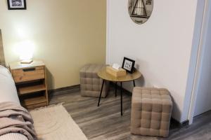 a bedroom with a table and a chair and a bed at Soarelui Cozy Studio in Braşov