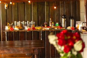 a table with plates of food and a bouquet of flowers at Beach House NATUREZA self check-in in Itacaré +34 photos