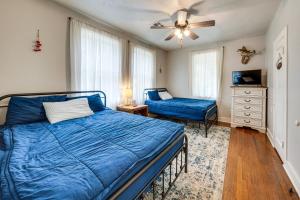 a bedroom with a blue bed and a dresser at Private Deck & Yard: Pet-Friendly Noble Getaway in Noble