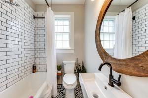a bathroom with a tub and a toilet and a mirror at Private Deck & Yard: Pet-Friendly Noble Getaway in Noble +15 photos