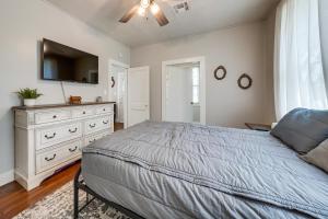 a bedroom with a bed and a dresser with a tv at Private Deck & Yard: Pet-Friendly Noble Getaway in Noble