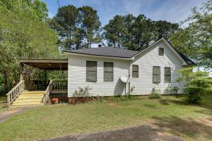a white house with a porch and a deck at Private Deck & Yard: Pet-Friendly Noble Getaway in Noble