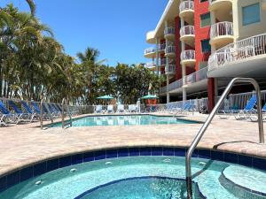 a swimming pool in front of a resort at August Beach Getaway Specials Book & Save! in St. Pete Beach