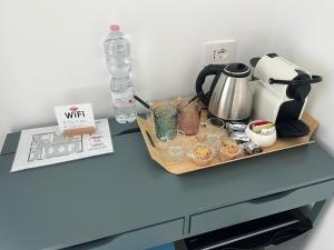 a table with a tray with glasses and a bottle of water at El Nido Suite in Tornavento