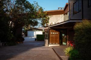 a building with a sidewalk in front of a building at Blue River Resort in Phitsanulok