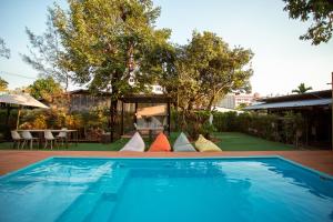 a swimming pool with colorful pillows in a backyard at Blue River Resort in Phitsanulok
