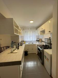 a kitchen with white cabinets and a stove top oven at The Olive Homes in Nairobi
