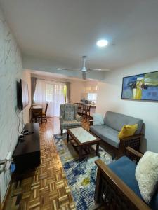 a living room with a couch and a table at The Olive Homes in Nairobi