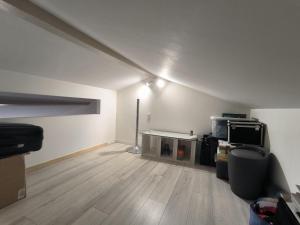 an empty living room with a table and a tv at Maison Tarnos in Tarnos