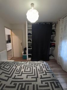 a bedroom with a black curtain and a bed at Maison Tarnos in Tarnos +2 photos