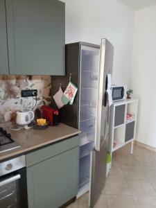 a kitchen with a refrigerator and a counter top at Il bosso in Ciriè