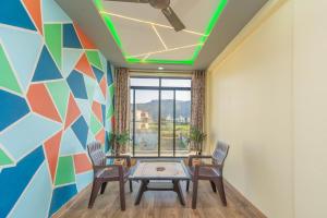 a room with a table and chairs and a colorful wall at Jalsa Bungalow in Malavli
