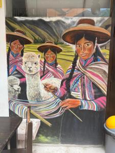 a painting of women and a cat on a wall at Hospedaje el Indi0 in Pisac