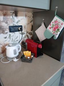 a kitchen counter with a coffee maker and a blender at Il bosso in Ciriè
