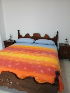 a bedroom with a bed with a colorful blanket at Il bosso in Ciriè