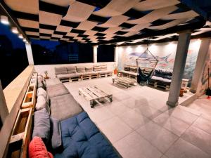 a room with couches and a hammock on a boat at Backpackers Home in Zadar