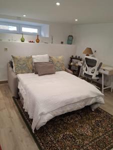 a bedroom with a large bed and a couch at La Casa del Río in Porto do Son