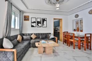 a living room with a couch and a table at A&C Blue Haven in Chefchaouen