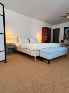 a bedroom with a large bed with a blue ottoman at ΑtoZ studio in Hydra in Hydra